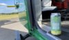 A can of yellow and green IPA in the open door of a helicopter. The IPA is in support of the Hampshire and Isle of Wight Air Ambulance.
