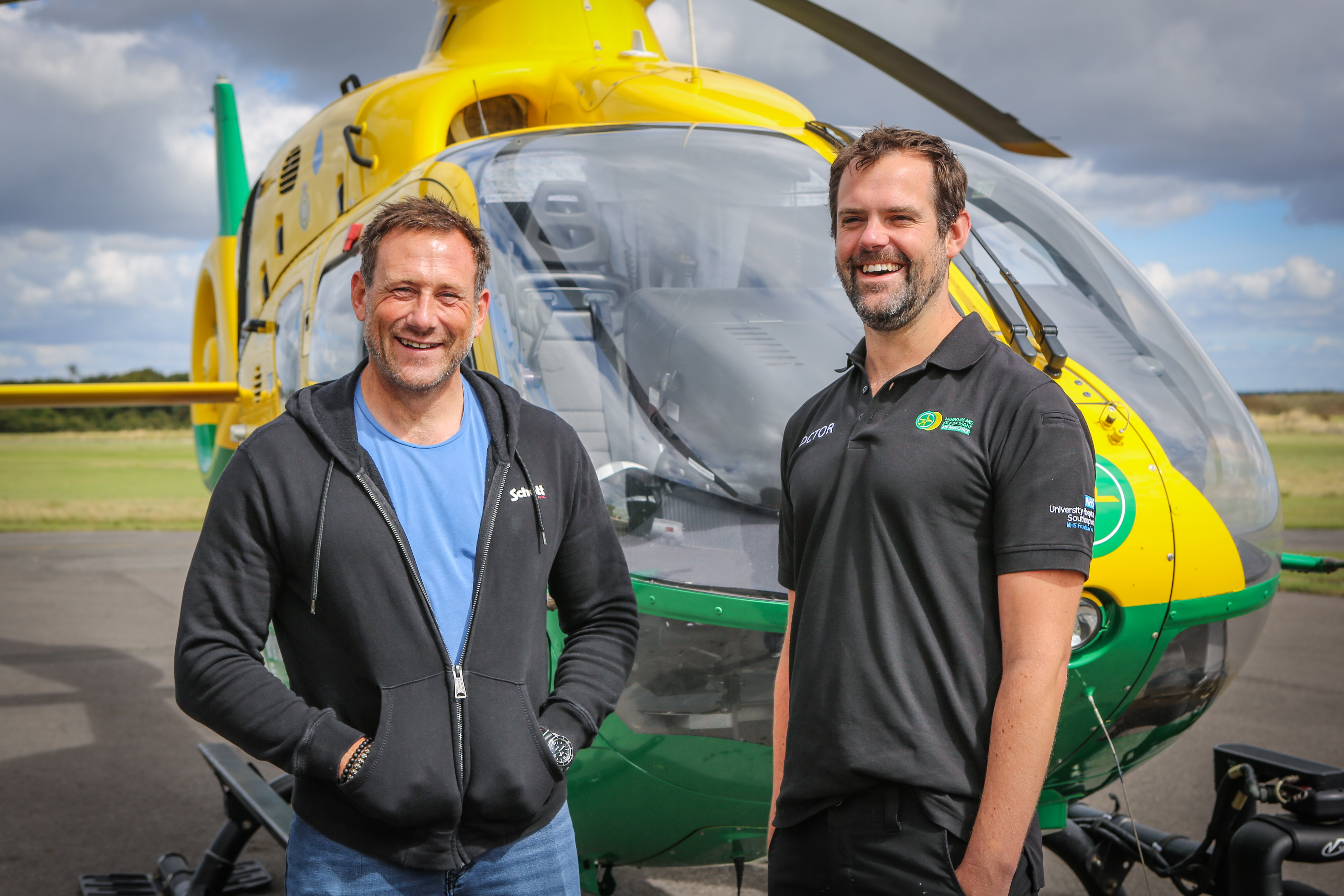 JAson Fox and Dr Matt Kerton stood in front of a helicopter