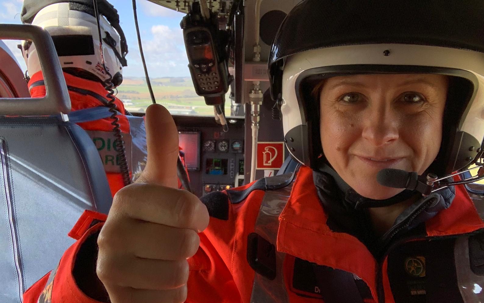 Dr Hania is in the back of the aircraft. They are in flight and she is giving you a thumbs up!