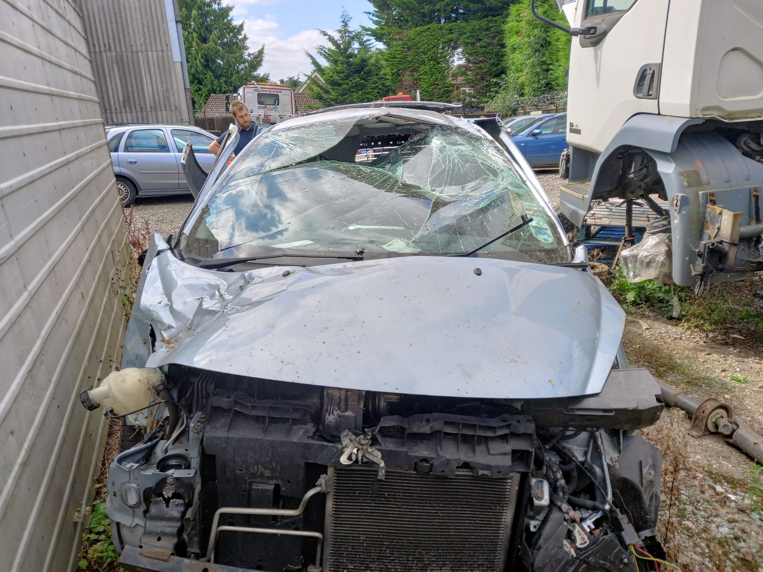 A car with its front end and window smashed