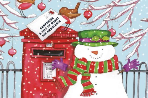 A snowman and two robins are posting a letter to Hampshire and Isle of Wight Air Ambulance at a red post box. 