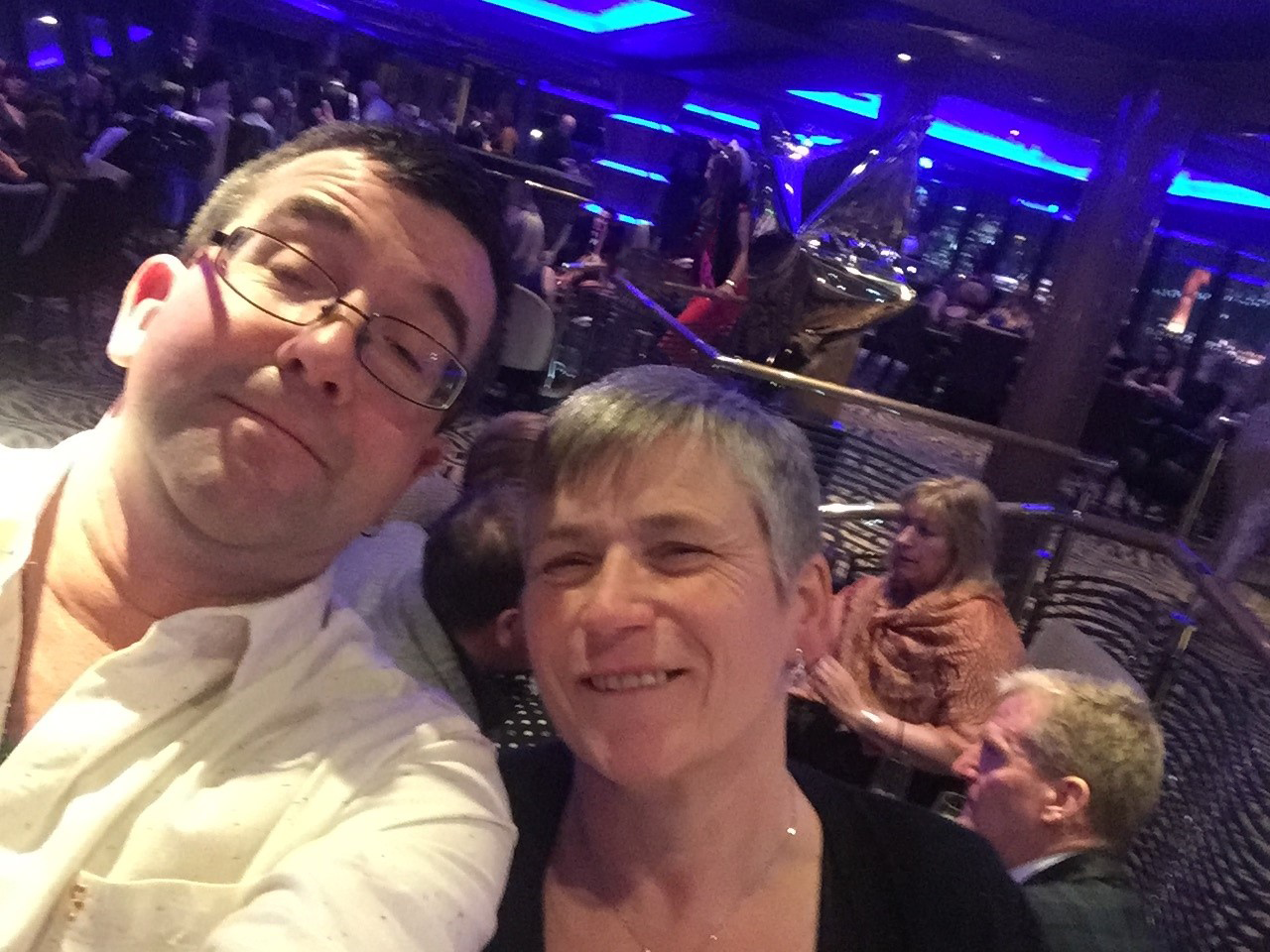 A man and a lady in a busy indoor setting