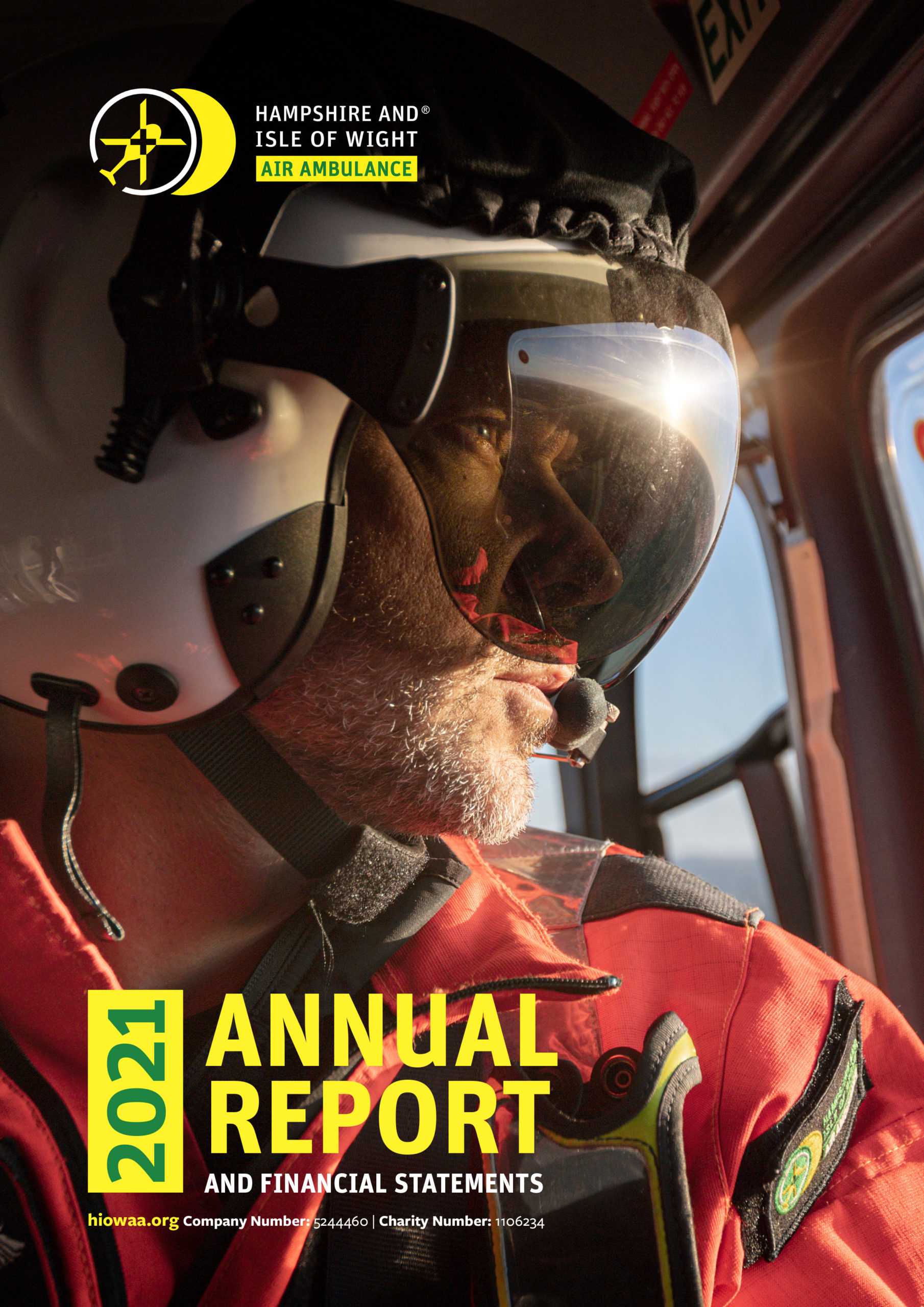 Annual Report 2020-21 - Front cover shows Dr Ben looking out of the helicopter window and the sun hitting the visor of his flight helmet