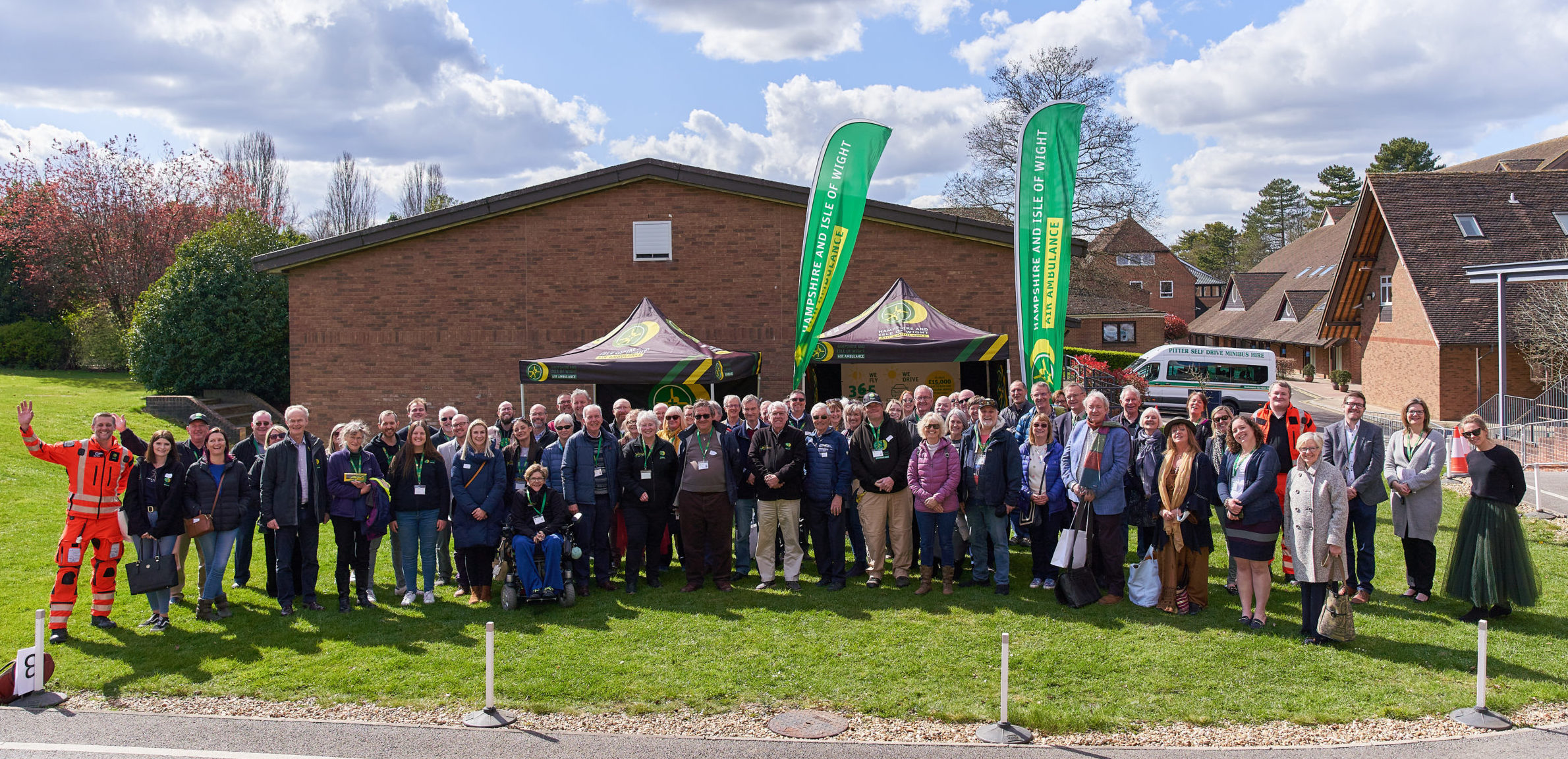 Volunteers, staff and crew smile for the camera