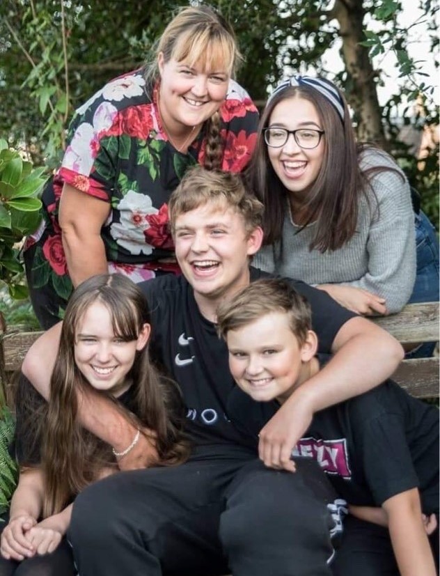 A group of people hugging and smiling