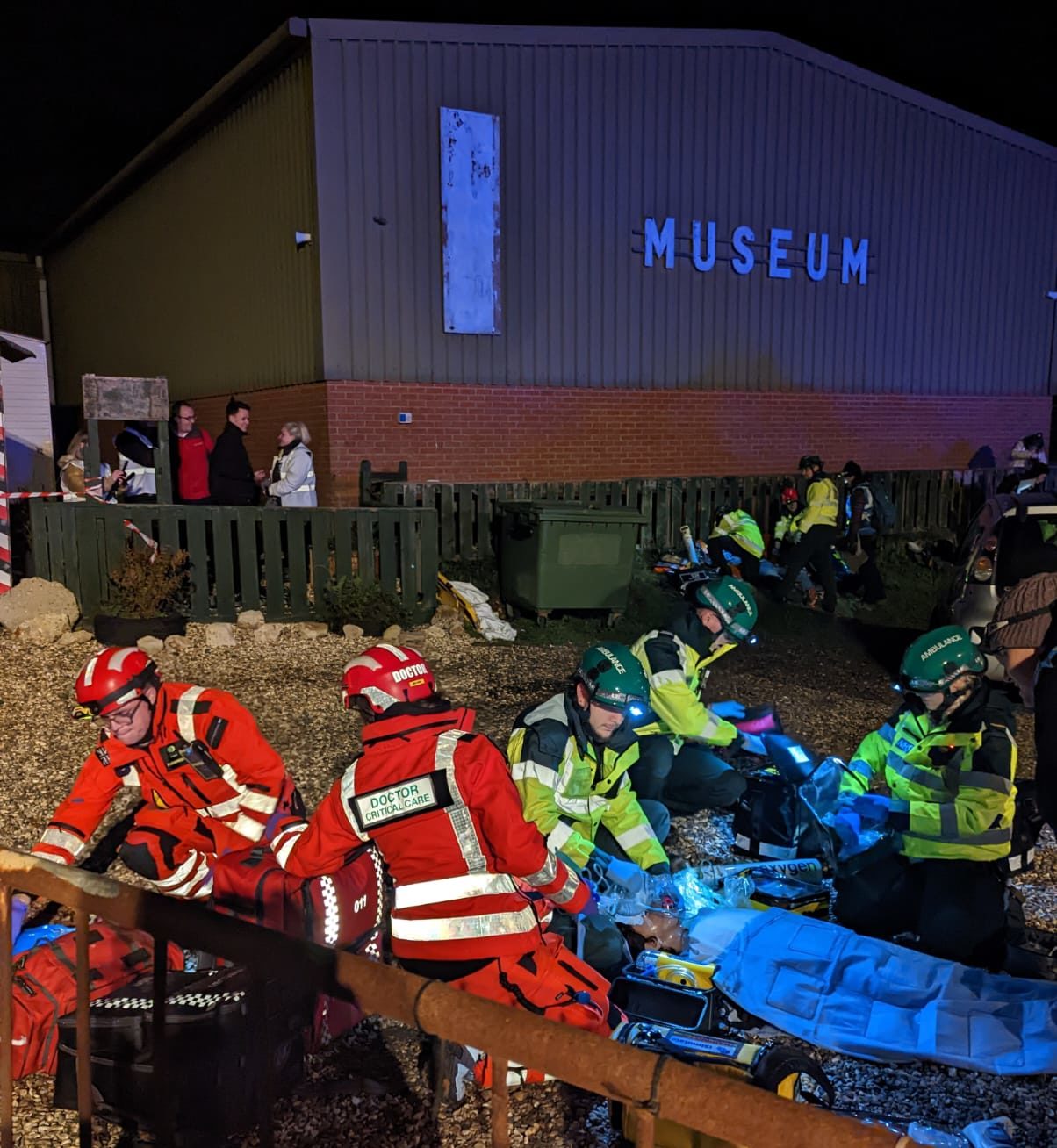A team of medical professionals involved in a training exercise at night