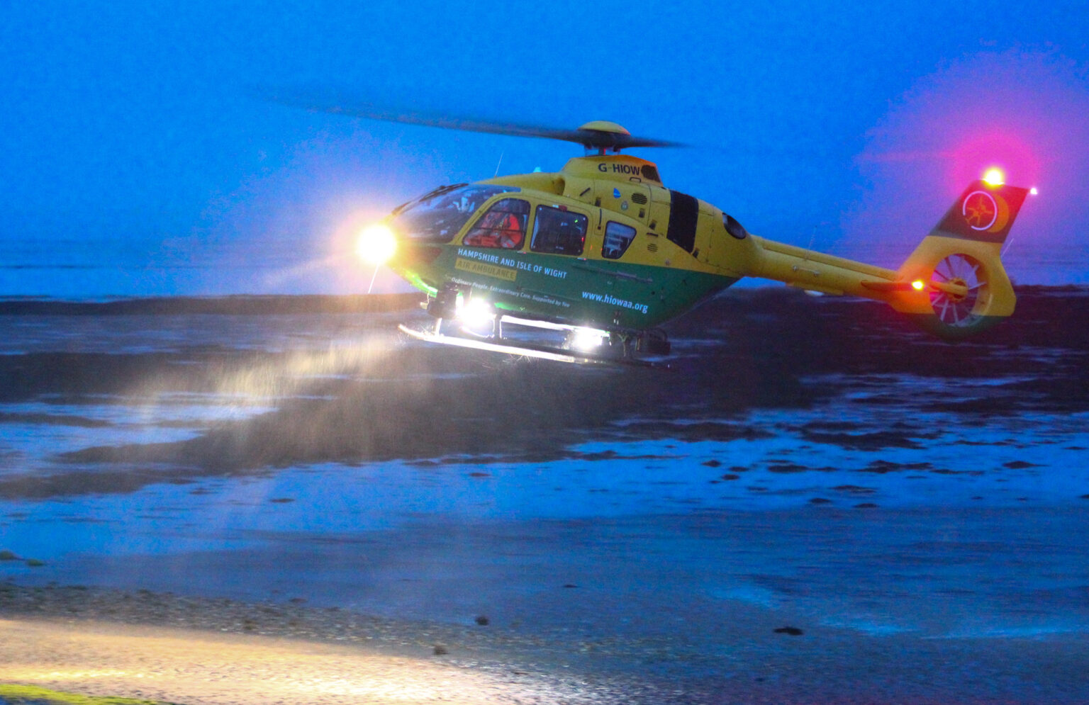 A helicopter coming in to land at night