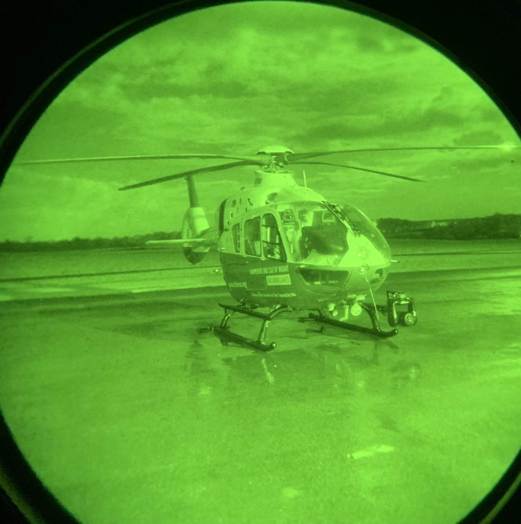 A helicopter through the view of night-vision goggles