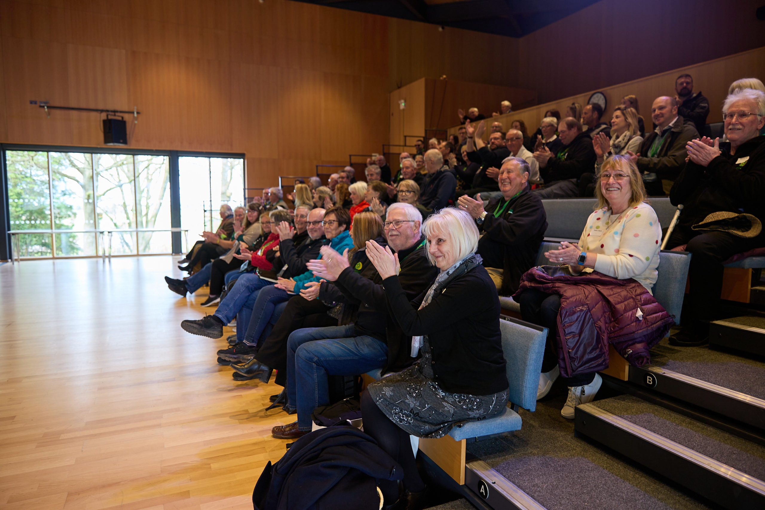 A room full of people applauding