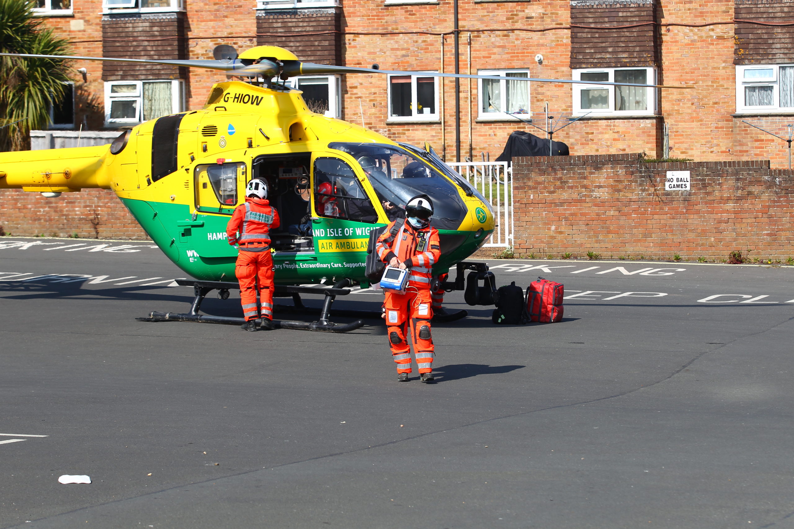 Air ambulance crew walking from a helicopter towards the patient