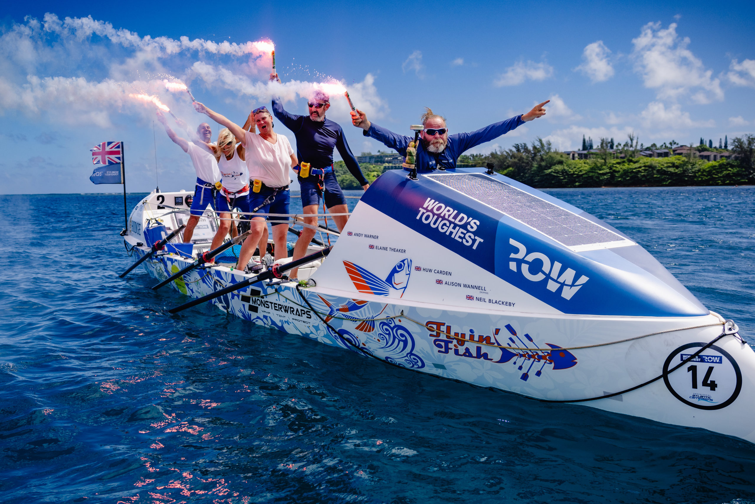 A group of people celebrate completing the world's toughest row.