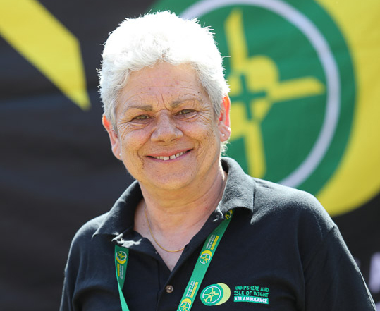 Volunteer Debbie is smiling to camera. She is wearing her charity t-shirt and lanyard.