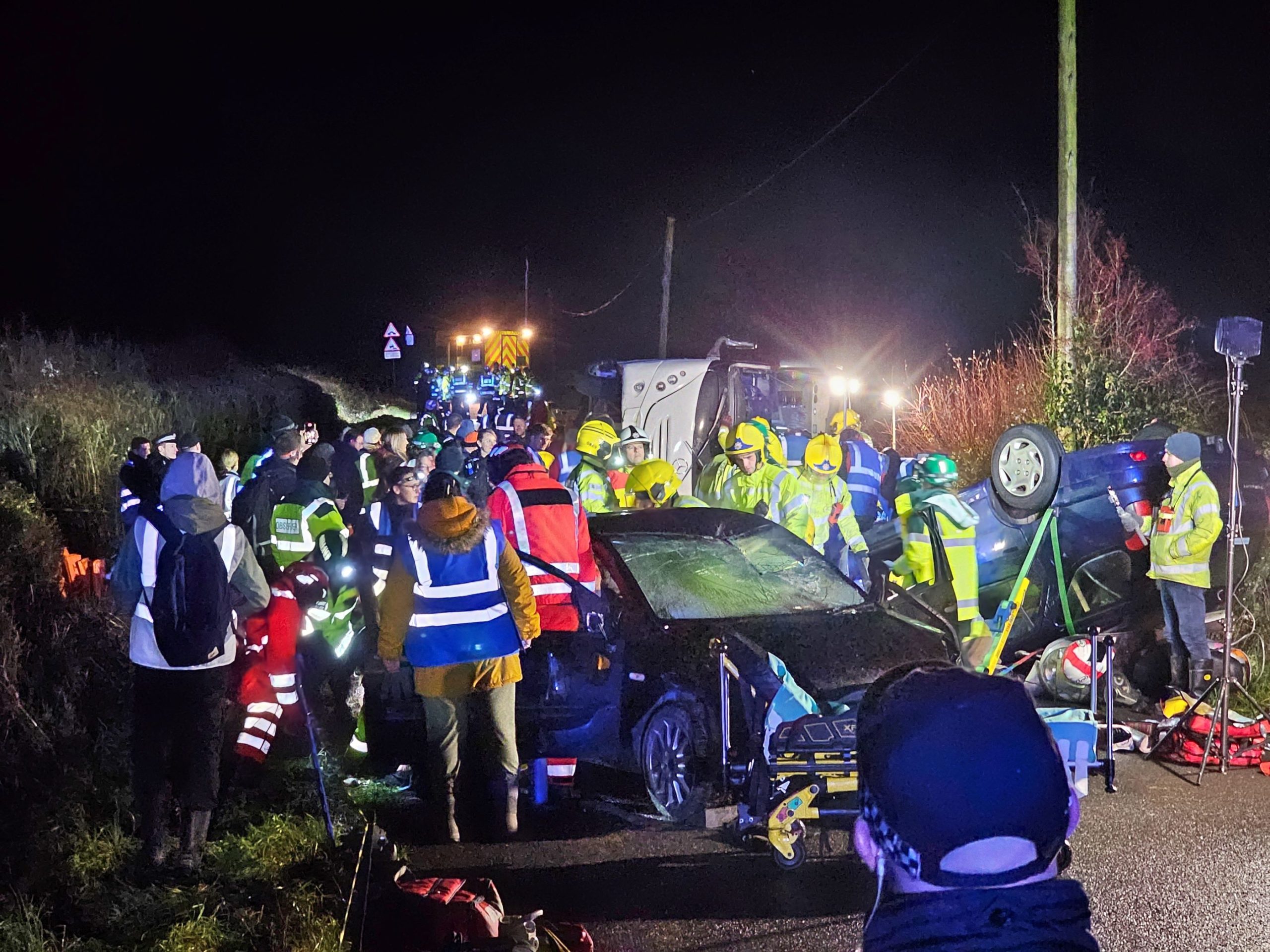 Emergency service personnel at a training simulation at night