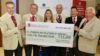 A group of people holding a large cheque for £45,000