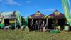 A group of HIOWAA volunteers stood in front of branded gazebos.