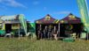 A group of HIOWAA volunteers stood in front of branded gazebos.