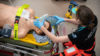 A doctor working on a manikin in a training simulation.