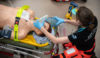 A doctor working on a manikin in a training simulation.