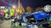 An upturned car with emergency service personnel at a training simulation