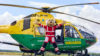 Teddy Medic mascot star jumping in front of the helicopter.