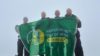 Four Hampshire Police Officers holding a Hampshire and Isle of WIght Air Ambulance flag.