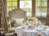 A luxury champagne afternoon tea prepared on a white linen table at the Tylney Hall Hotel