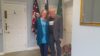 A man and a woman standing side by side looking at the camera.