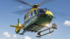 Our helicopter, Helimed 56, is in flight. The sky is blue and the search light underneath is on.