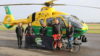 People stood in front of a helicopter