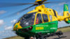 A person sat in the front of a helicopter before take-off