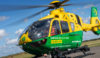 A person sat in the front of a helicopter before take-off