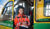 A paramedic sat in a helicopter holding her flight helmet.
