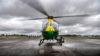 A helicopter with grey skies and low cloud